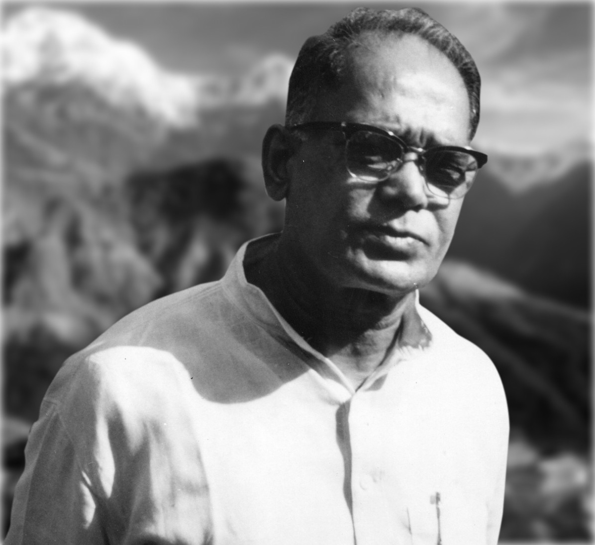 Studio portrait of Jaya Prakash Narayan in a white kurta, photographed against a painted mountain backdrop