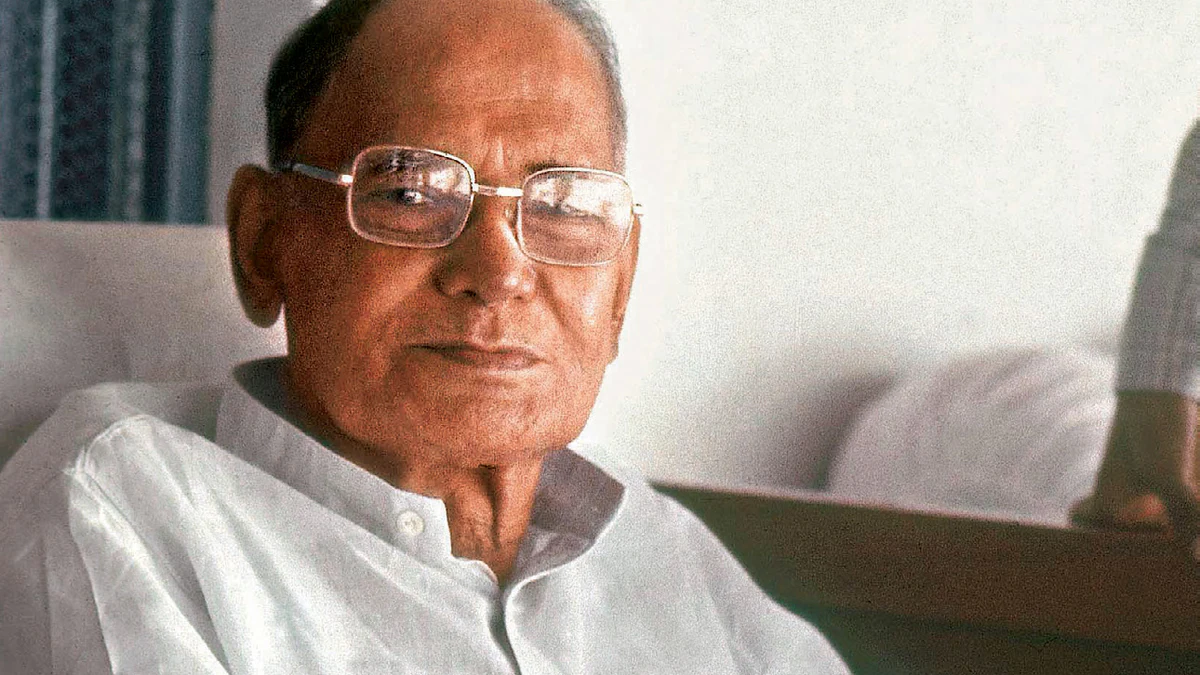 Colour photograph of Jaya Prakash Narayan in later life, seated in a white kurta