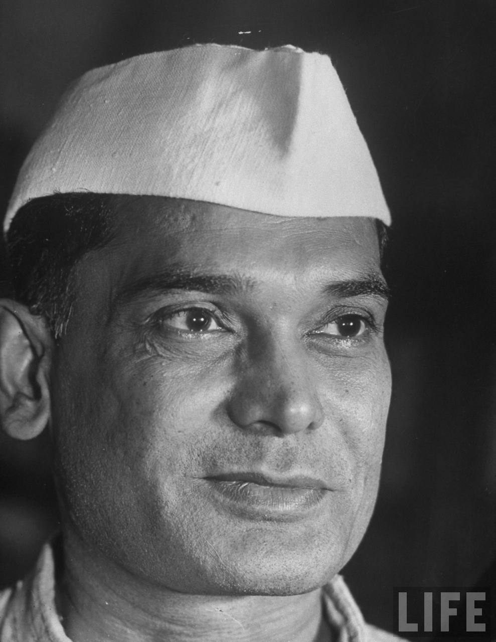 Close portrait of a younger Jaya Prakash Narayan wearing a white Gandhi cap